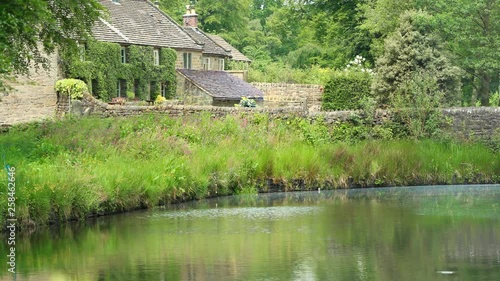 Picturesque stone bridge and the Pond Cottages over the Bentley Brook, Peak District, England. Panorama. photo