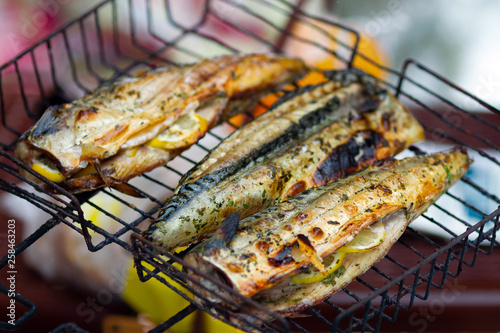 Mackerel fish with lemon and spices on the rack closeup