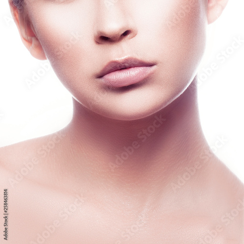 Lips, part of face of beauty model girl. Perfect skin, natural nude makeup. Pale lipstick. Skincare facial treatment concept