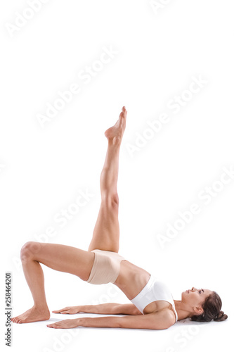 Yoga woman with perfect body in balance full length isolated on white.