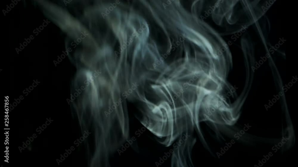 Smoke slowly rising graceful twists upward. Cigar smoke blowing from bottom to top. Natural color tobacco smoke. Great for editing, video without color correction and grading, 4K - 60fps Smoke slowly rising graceful twists upward. Cigar smoke blowing from bottom to top. Natural color tobacco smoke. Great for editing, video without color correction and grading, 4K - 60fps