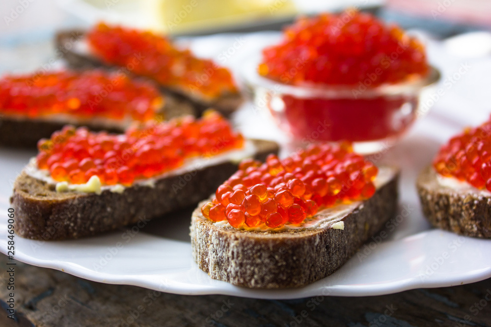 red caviar on black bread with butter. Healthy food. Fish appetizer. red caviar on black bread with butter. Healthy food. Fish appetizer.