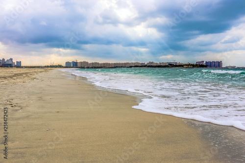 Horizon of Seascape  water waves at Jumeirah Beach under cloudy sky in Dubai  United Arab Emirates