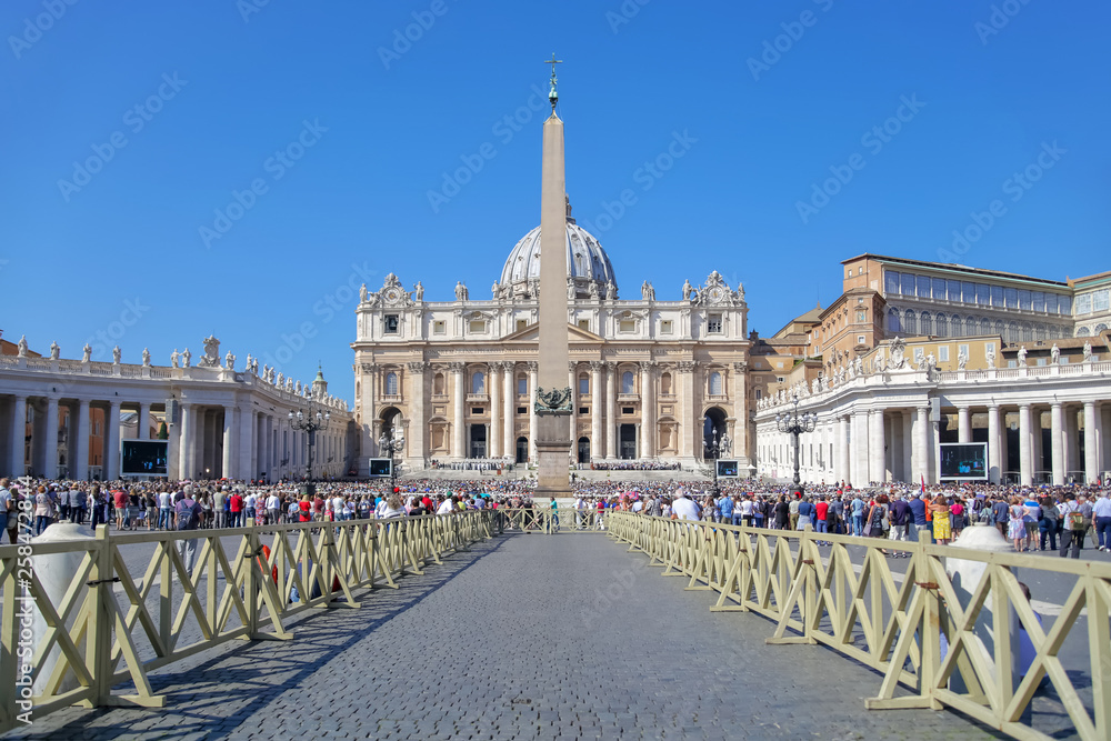 St. Peter's Basilica and Vatican obelisk against blue sky