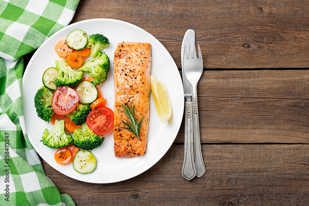 Baked salmon fillet with broccoli and vegetables mix. Baked salmon fillet with broccoli and vegetables mix.