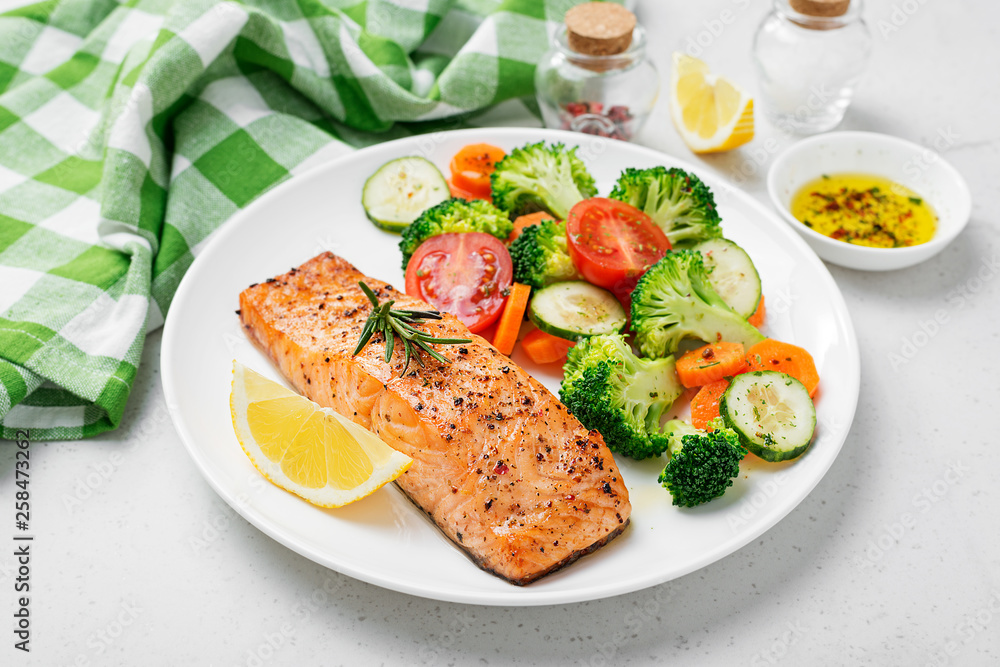 Baked salmon fillet with broccoli and vegetables mix. Baked salmon fillet with broccoli and vegetables mix.