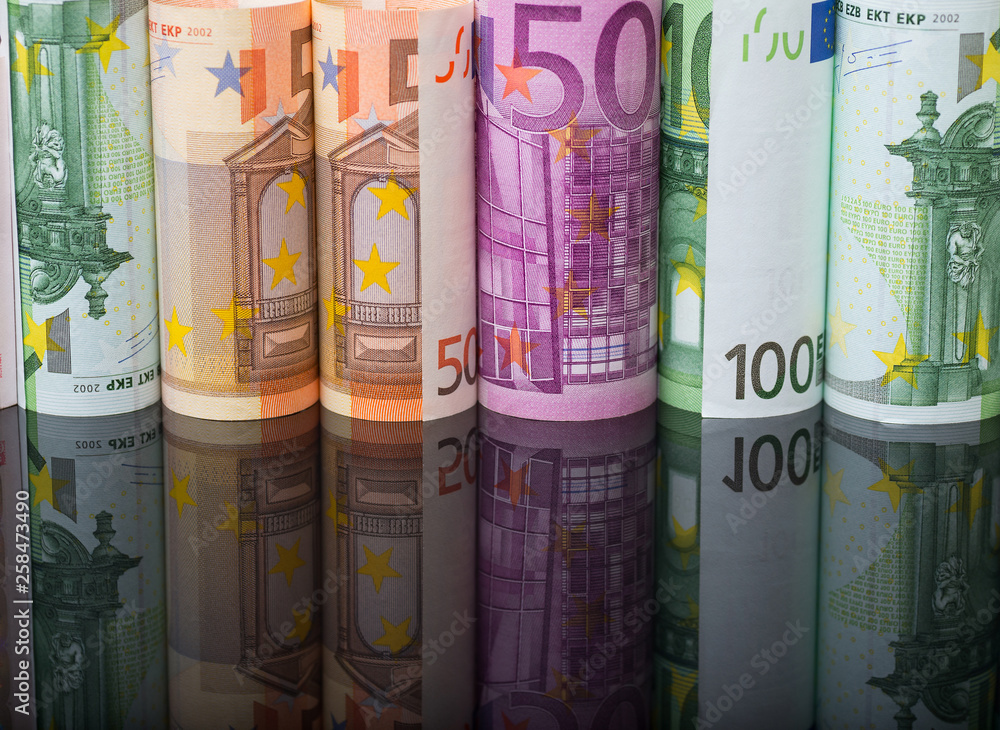 European paper money in rolls on black background with reflection. European paper money in rolls on black background with reflection.