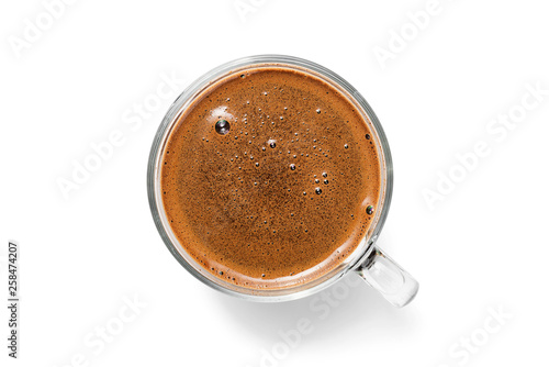 Glass cup of coffee isolated on white background from top view .