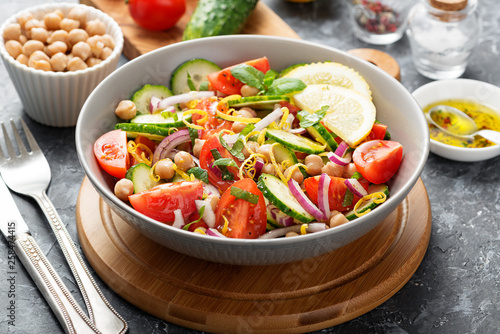 Salad of chickpeas, tomatoes, cucumbers and greens. Dietary food. Vegan salad.