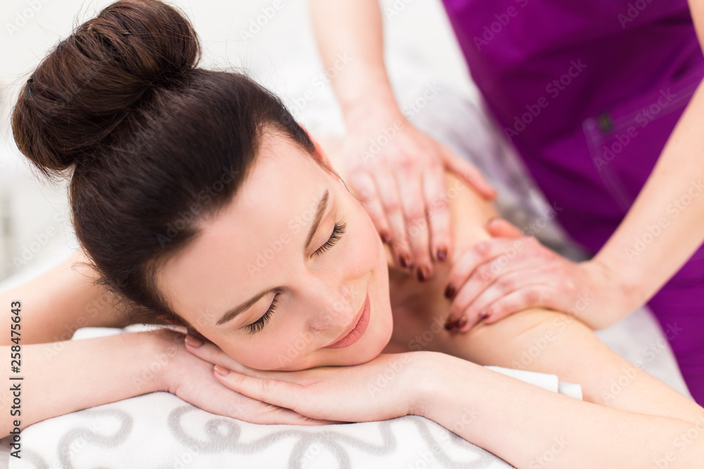 Beautiful brunette at a massage in a spa