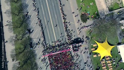 Aerial view from drone on crowd of people who is starting their run on marathon event.