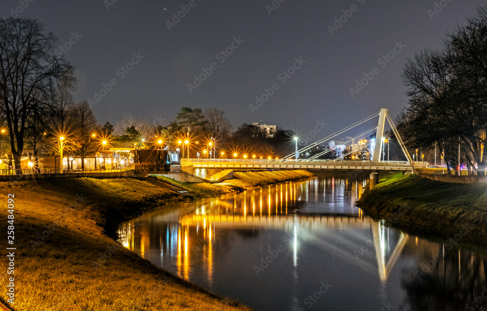 Fototapeta premium Illuminated bridge over the river, Nitra, Slovakia, night