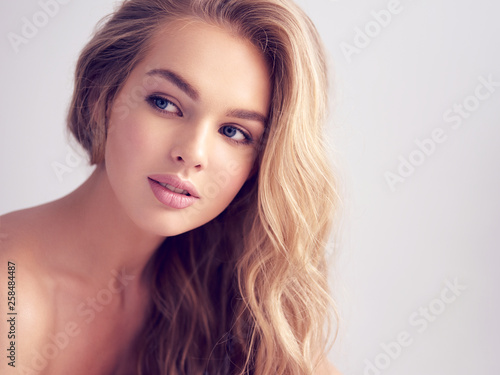 Young blond woman with long curly hair.