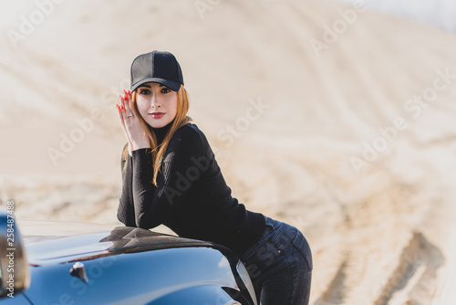 Photography Woman wear black turtleneck, jeans and baseball cap, girl in sand desert