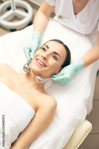 Top view of the cryo-sticks massage of smiling woman