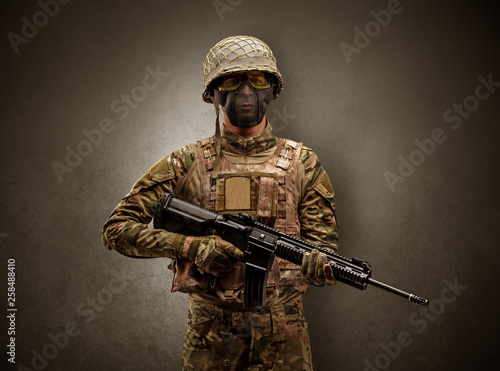 Soldier agent in a dark room with arms on his hand and gas mask 
