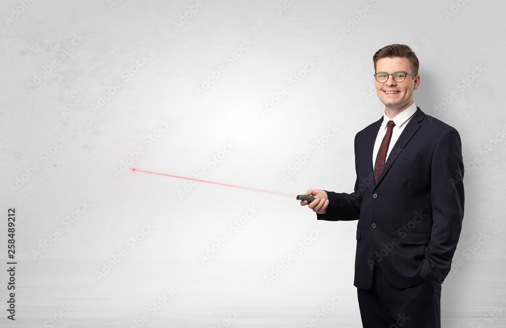 Young businessman with laser pointer and copyspace white wall
Young businessman with laser pointer and copyspace white wall