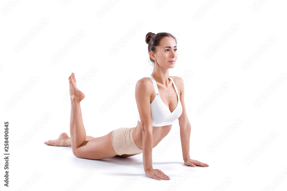 Beautiful young woman doing yoga or pilates exercise isolated on white background. Beautiful young woman doing yoga or pilates exercise isolated on white background.