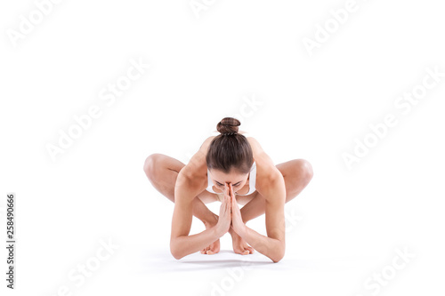 Woman doing yoga practice isolated on white background. Yoga master.