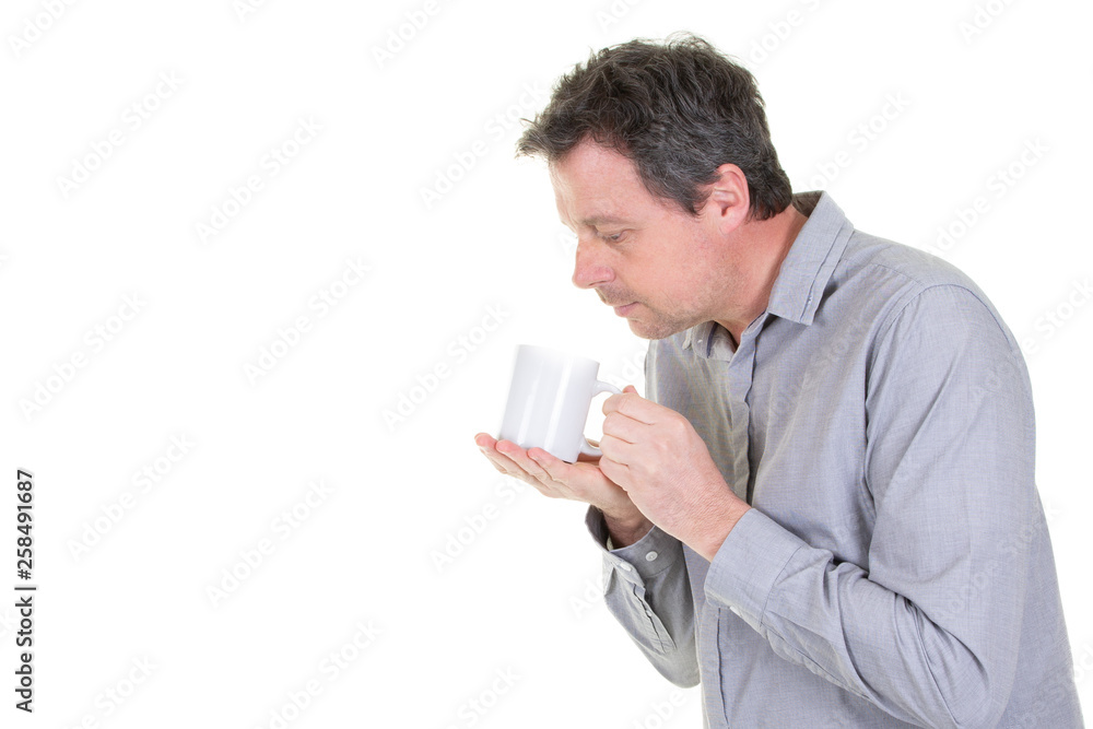 Studio portrait of handsome man holding tea mug or cup of coffee Studio portrait of handsome man holding tea mug or cup of coffee
