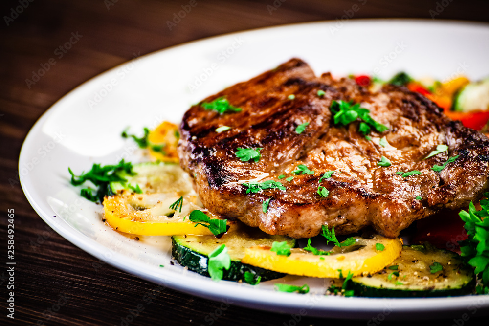 Grilled steak with potatoes and vegetable salad Grilled steak with potatoes and vegetable salad