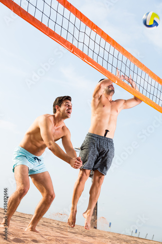 Two friends are playing in volleyball