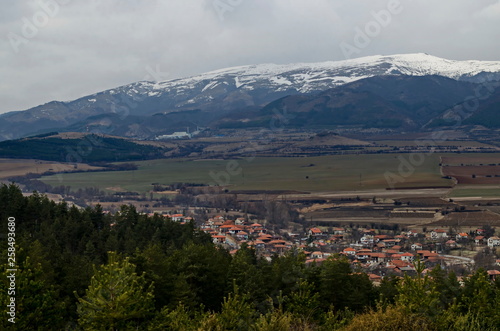 Part of the Zlatitsa Pirdop valley and residential district of village Chavdar close in background of the snowy Balkan mountain, Sofia, Bulgaria, Europe 