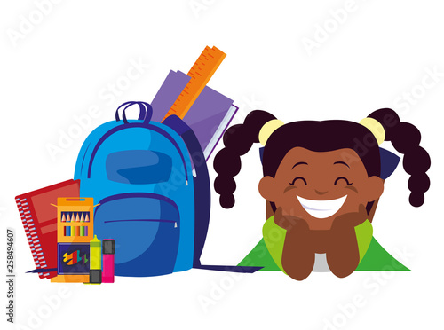 happy little black schoolgirl with schoolbag and supplies