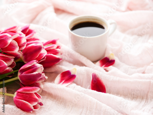 Cup of coffee and pink tulips