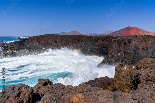 Spain, Lanzarote, Breathtaking loud breaking waves in tourist attraction los hervideros bay © Simon