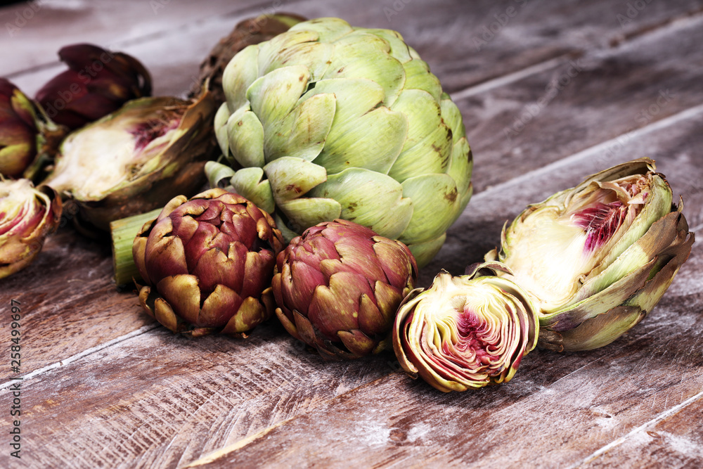 Obraz premium artichokes on grey background. fresh organic artichoke flower vegetable