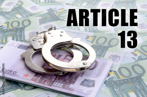 Police handcuffs on euro bills and article 13 inscription. European copyright directive including article 13 is approved by european parliament photo