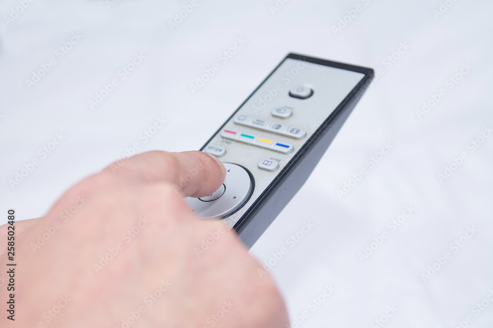 closeup adult man with tv remote control closeup adult man with tv remote control