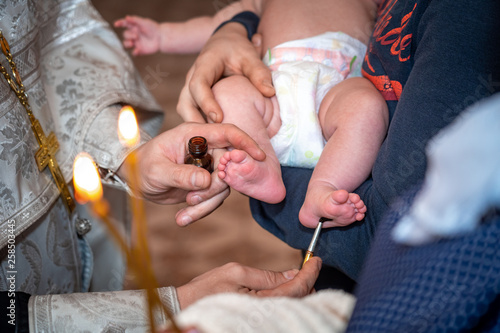 baptism of a child in the Church, the process of anointing photo