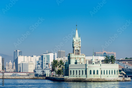 The historical building and Fiscal Island (Ilha Fiscal) in the Guanabara bay with the city centre and cathedral in the background on a bright sunny day