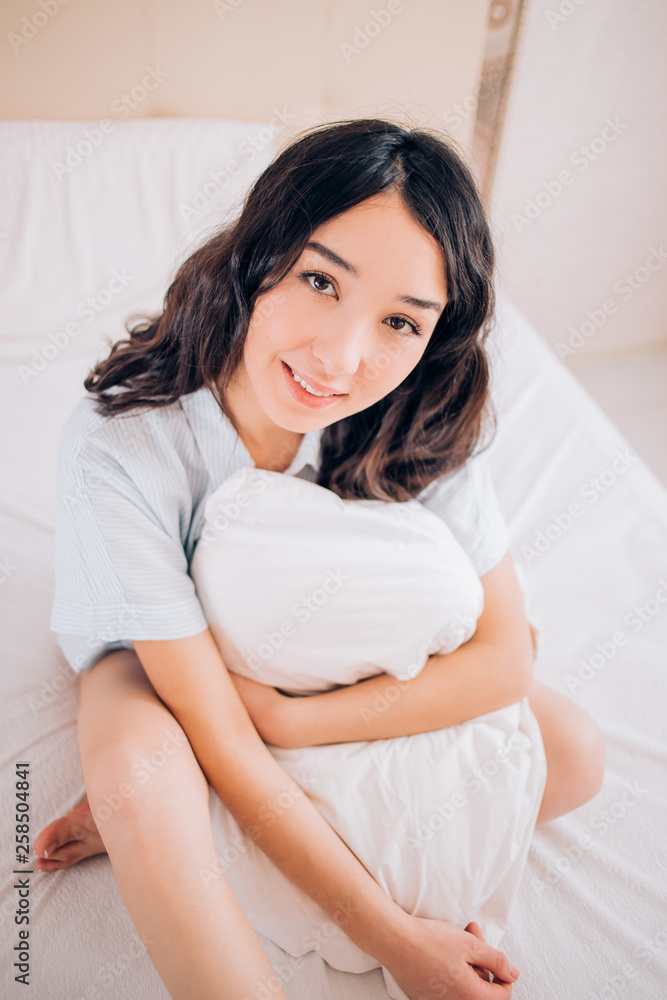Beautiful Positive woman sitting in bed in morning Beautiful Positive woman sitting in bed in morning