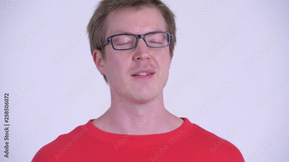 Face of happy young handsome man relaxing with eyes closed Face of happy young handsome man relaxing with eyes closed