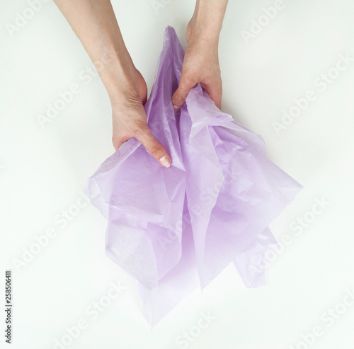 Wallpaper Mural girls hands are holding crumpled purple wrapping paper on white background Torontodigital.ca