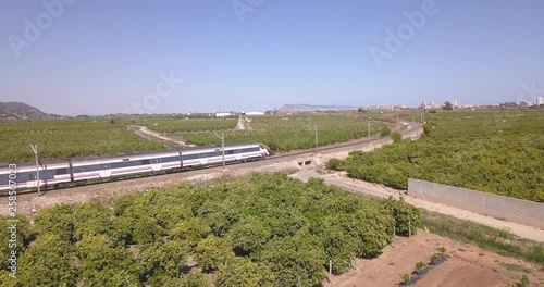 Drone point of view shot of train passing in the countryside in Spain