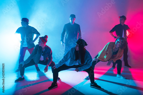 Photography Group of male and female dancers in colorful neon light having fun dancing