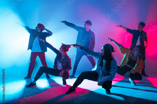 Fotografiet Group of diverse young hip-hop dancers in studio with special lighting effects i