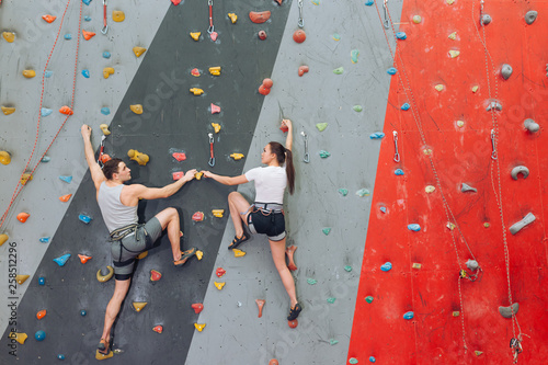 Married couple having unusual date at rock wall.copy space
