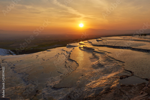 Beautiful sunrise and Natural travertine pools and terraces in Pamukkale.