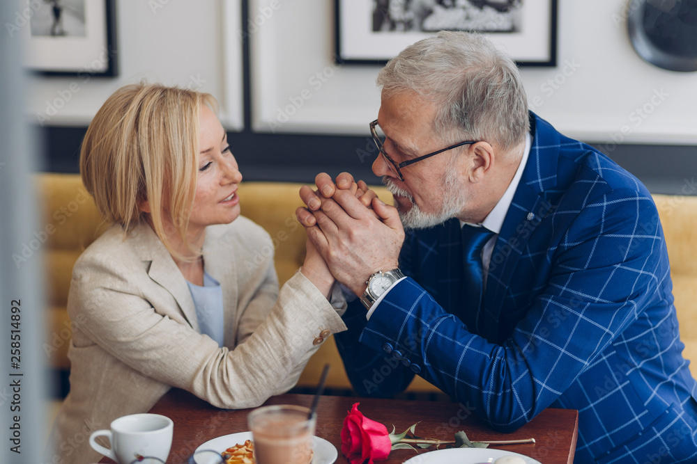 elegant man adores his woman. handsome man enjoying the time with his first love. meeting after many years elegant man adores his woman. handsome man enjoying the time with his first love. meeting after many years