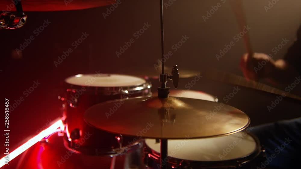 male drummer, play lesson hi hat at the red drum set and the blue snare drum, at the rehearsal studio, low neon red light male drummer, play lesson hi hat at the red drum set and the blue snare drum, at the rehearsal studio, low neon red light