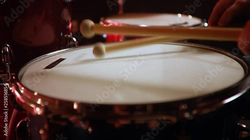 drummer, jazz lesson , percussion drumsticks , drumroll on a snare  a rehearsal studio on a red drums , low key, close-up photo