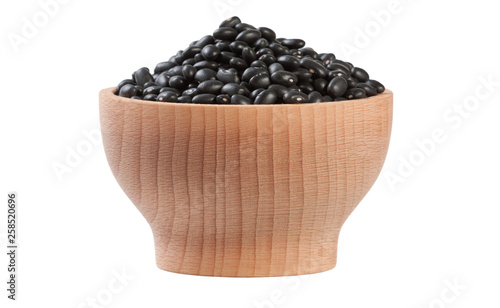 black bean in wooden bowl isolated on white background. nutrition. food ingredient.