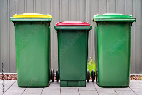 Australian home waste wheelie bins set on backyard photo
