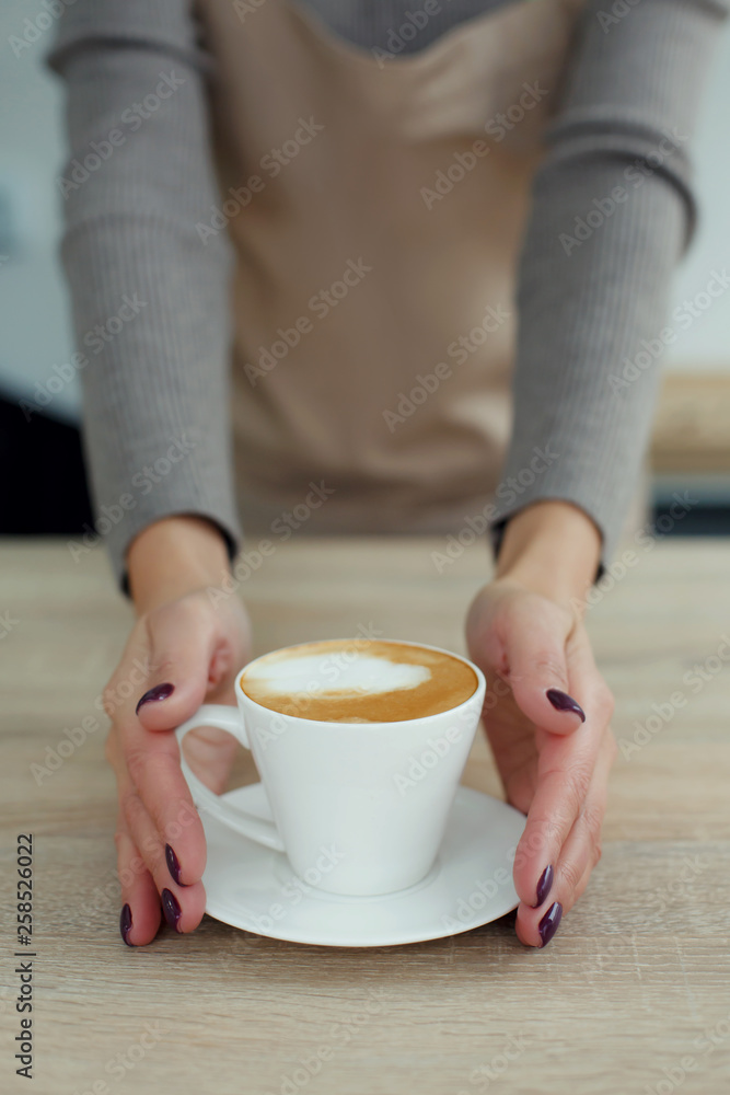 Barista in apron in coffee shop give just brewed fresh coffee to customer Barista in apron in coffee shop give just brewed fresh coffee to customer