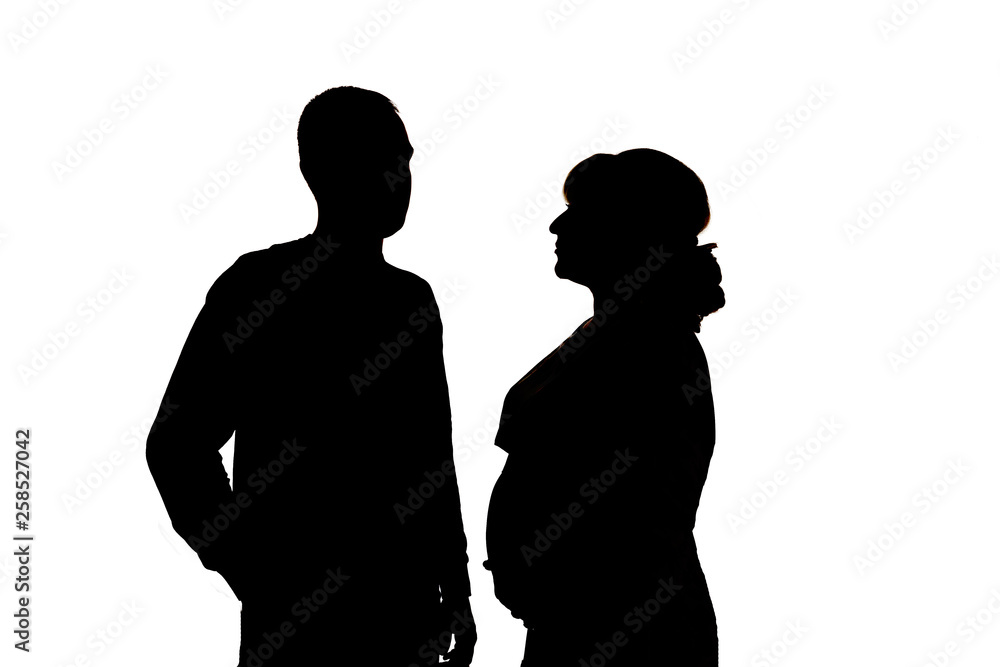 A pregnant woman and a man. Black silhouettes on white background. In isolation